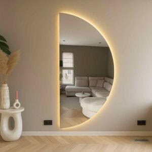 Lichtgevende ronde spiegel in modern interieur met zithoek in neutrale kleuren. Elegant en sfeervol decor voor een gezellige woonkamer.